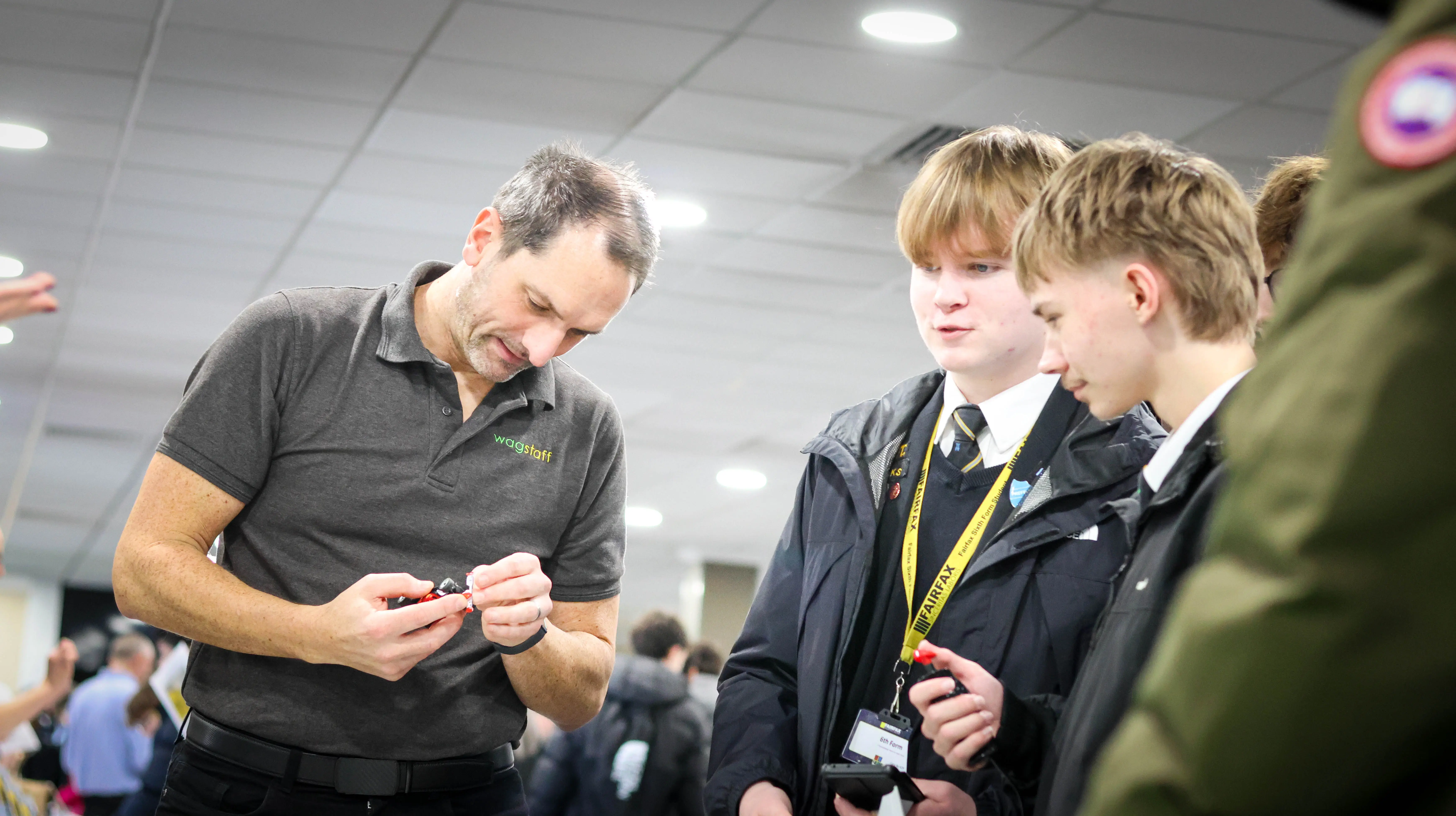 Exhibitor and student looking at scalextric