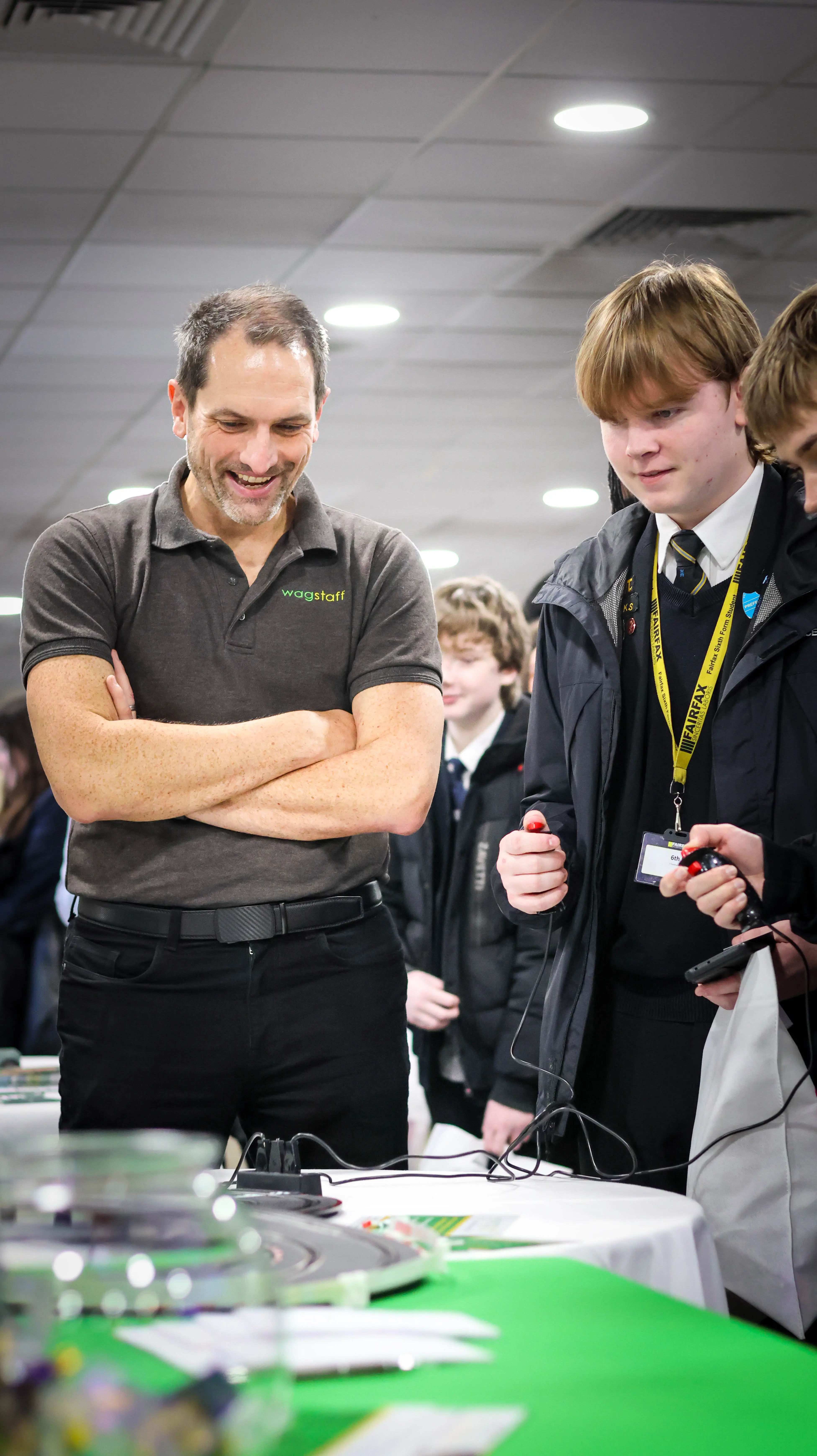 Exhibitor and student looking at scalextric