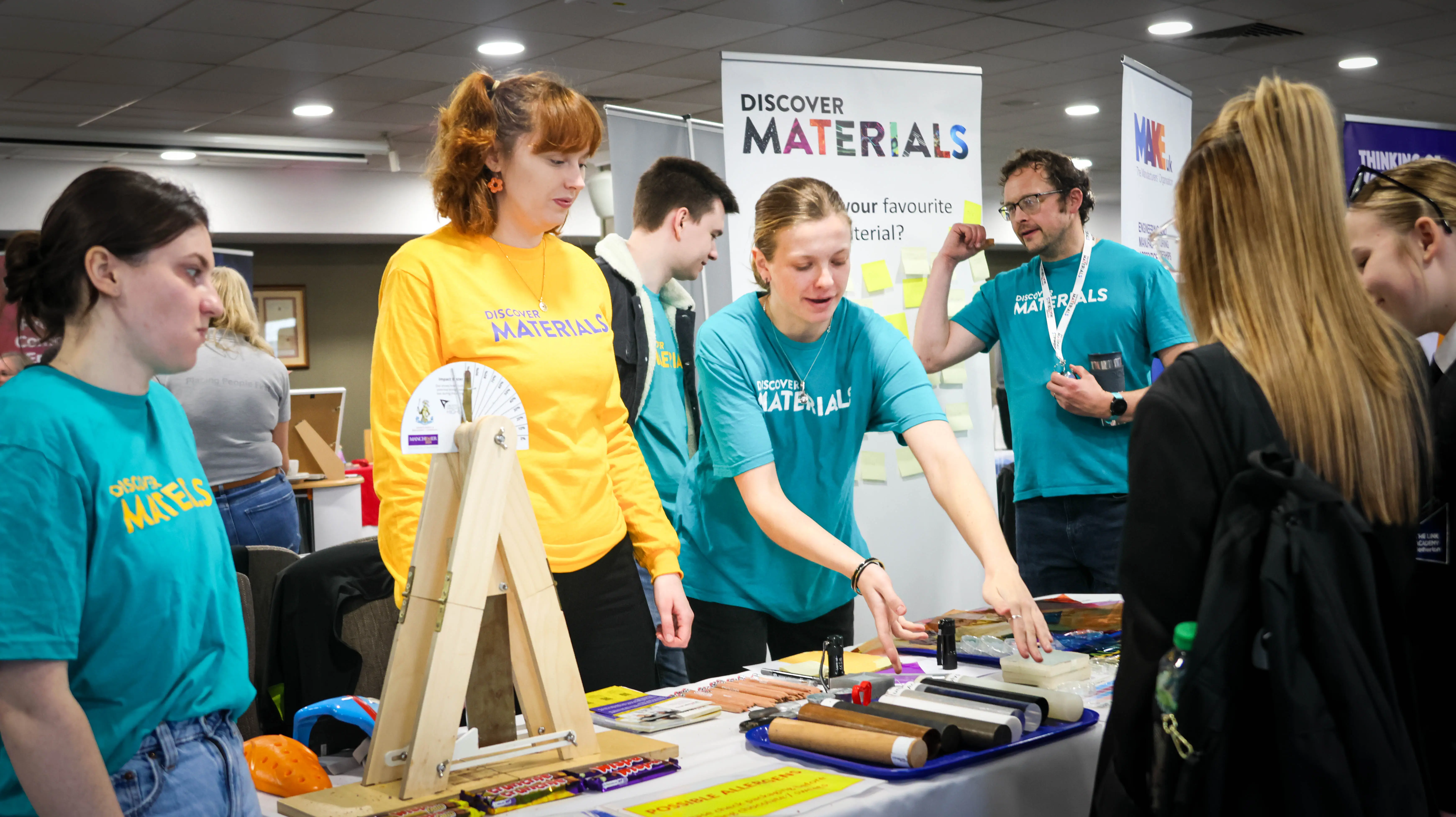 Exhibitor showing different materials to a student